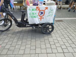 Ein Lastenbike mit der Aufschrift Flinta Leben Freiheit und einem queerfeministischen Zeichen mit Piratenflagge